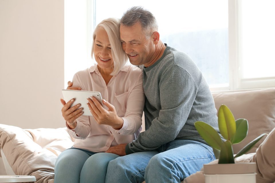 An older couple at home together, smiling
